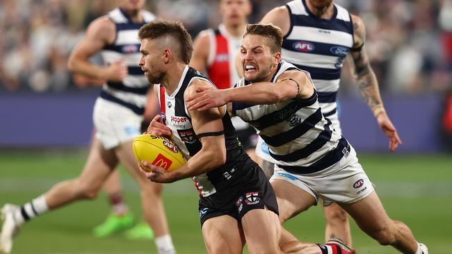 Tom Atkins chases down Saint Dan Butler in Saturday night’s win. Picture: Graham Denholm/AFL Photos