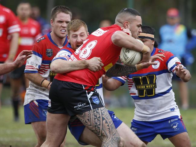 St Clair’s David Haumono is wrapped up by Richard Starr. Picture Warren Gannon Photography