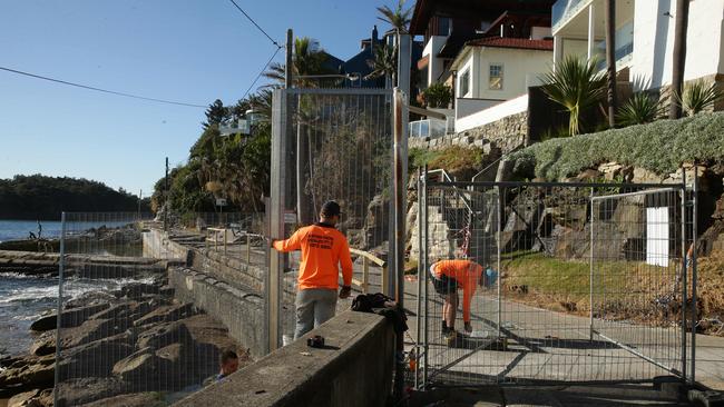 A huge fence, stretching from the rocks across the path. Workmen were in the process of replacing a smaller fence with a more solid structure on Thursday.