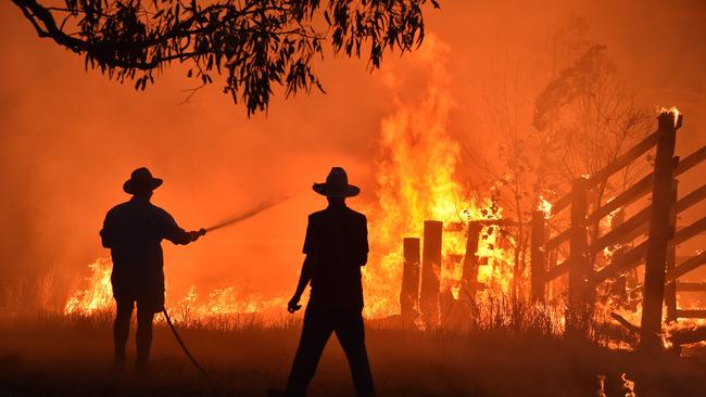 The fire threat will continue across Queensland with the mercury expected to climb to near-record temperatures this week. Picture: PETER PARKS / AFP