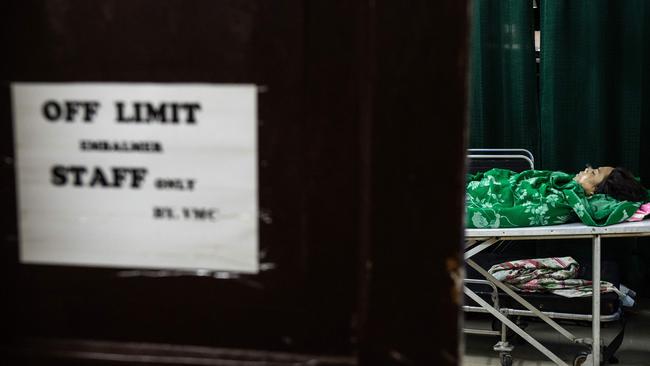 An embalmed body of an alleged drug dealer killed by unidentified men inside the morgue of Veronica Memorial Chapel in Manila. Picture: AFP / Noel CELIS / TO GO WITH Philippines-Duterte-drugs-crime-death, FOCUS by Ayee MACARAIG