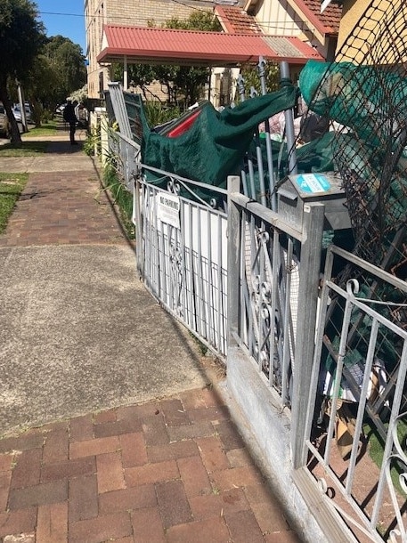 There is so much rubbish being hoarded it barely stays in the caged yard.