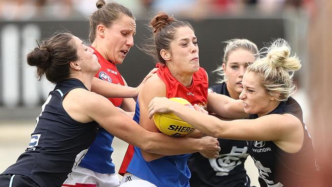 Lauren Pearce tries to burst through the pack.