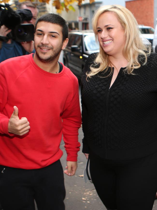 Rebel Wilson with a fan outside court.