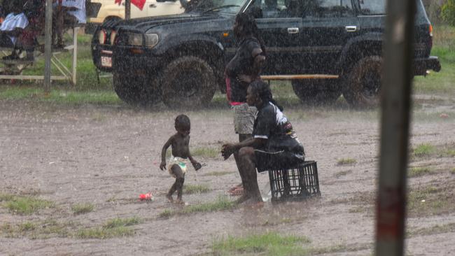 A mother an her baby stuck it out in the rain. Picture: Darcy Jennings