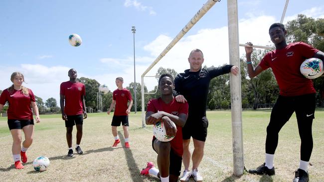 Student Musa Toure with High School academy director Josh Hilditch and Adelaide United's Mohamed Toure, with the academy students Mia Kasperski 15, Chicco Nyirenda 16, and Alex Tsimopoulos. Picture: Kelly Barnes.