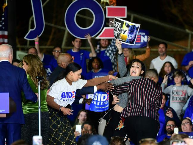 A dairy industry protester was removed from the stage as Joe Biden addressed supporters. Picture: AFP