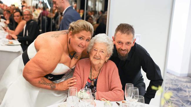 Rebecca Stone and Richard Johnson with a guest at their Luna Park wedding. Picture: Facebook.