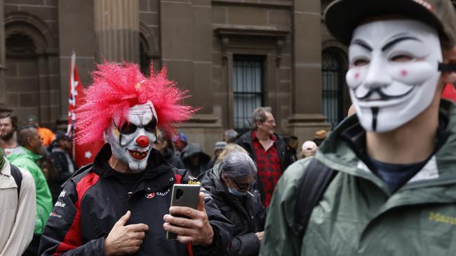 Masked protesters in the crowd. Picture: Alex Coppel.