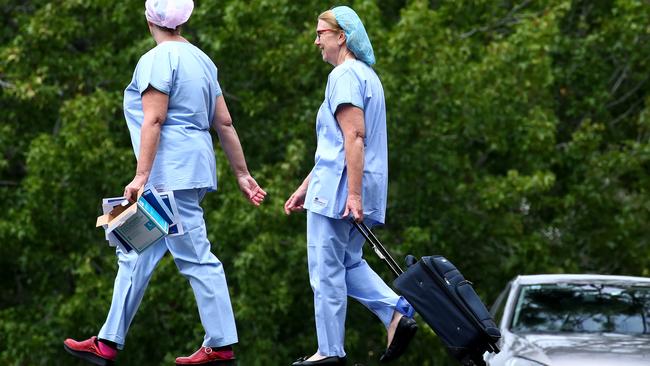 Workers at Dorothy Henderson Lodge in Macquarie Park, part of the Baptist Care Aged Care facility, where a staff member tested positive to the coronavirus this week. Picture: Toby Zerna