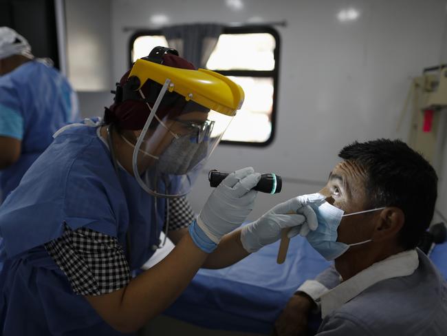 A doctor checks over a patient in Mexico City. Picture: AP