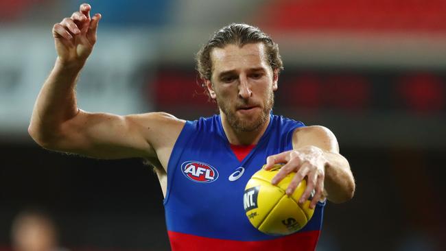 GOLD COAST, AUSTRALIA - JULY 12: Marcus Bontempelli of the Bulldogs kicks during the round 6 AFL match between the Carlton Blues and the Western Bulldogs at Metricon Stadium on July 12, 2020 in Gold Coast, Australia. (Photo by Chris Hyde/Getty Images)