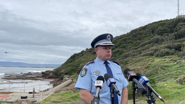 Superintendent Craig Iredale speaking at Hill 60 on Tuesday morning as a PolAir chopper search for the missing man in the background. Picture: Dylan Arvela