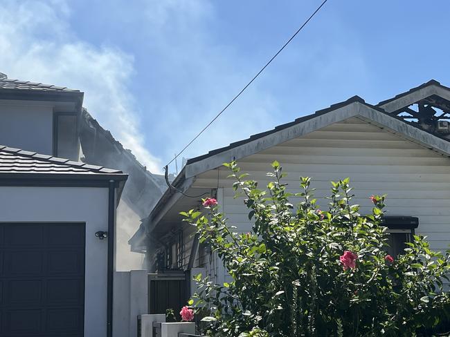 A team of six fire trucks and 22 firefighters attended the scene at 12:27pm and found a two-level home with heavy fires erupting through roof. Picture: FRNSW