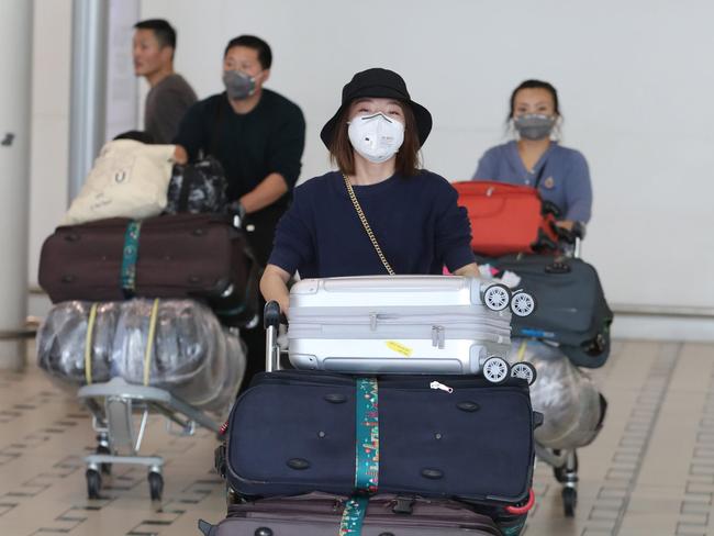 People arrive from Shanghai into Brisbane International Airport. Pic Peter Wallis