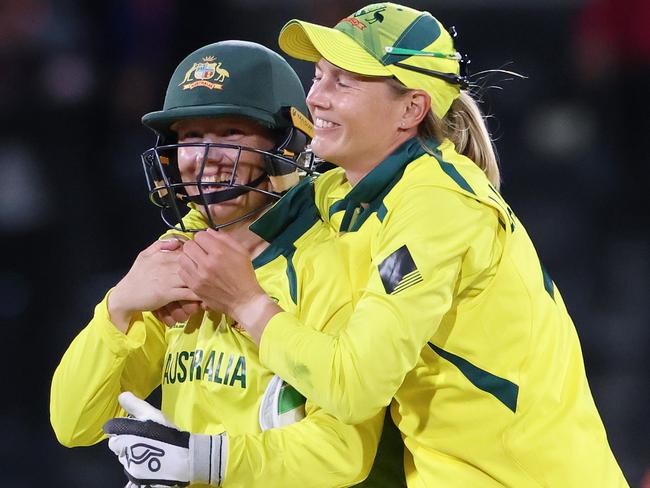 CHRISTCHURCH, NEW ZEALAND - APRIL 03: Alyssa Healy (L) and Meg Lanning of Australia celebrate after winning the 2022 ICC Women's Cricket World Cup Final match between Australia and England at Hagley Oval on April 03, 2022 in Christchurch, New Zealand. (Photo by Peter Meecham/Getty Images)