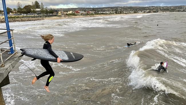 Noah Saunders took advantage of the storm to get a rare surf at the normally flat Brighton Beach. Picture: Nathan Davies