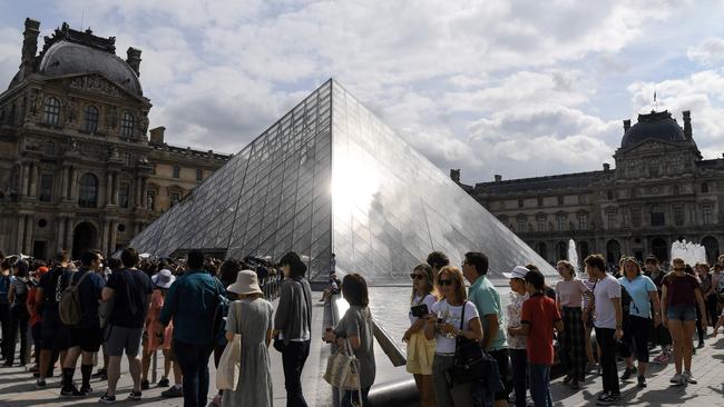 Tourists queue prior to entering the Louvre museum in Paris. Picture: Alain Jocard