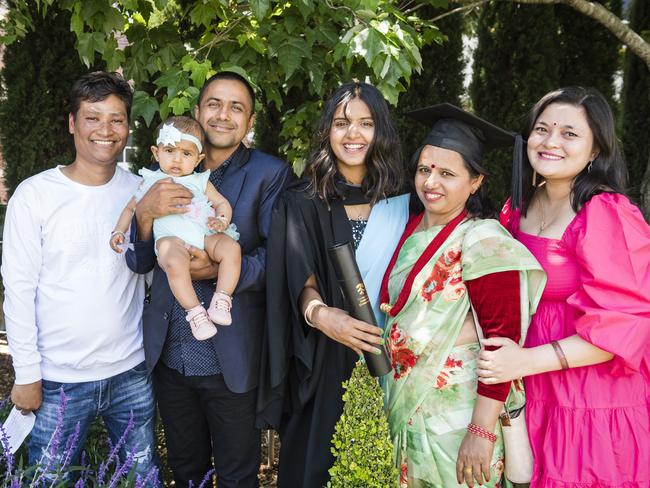 Graduate Santoshi Dhungana with family and friends (from left) Raju Shrestha, Bikash Poudel holding Saadhvi Poudel, Bindu Dhungana and Asmita Shrestha at a UniSQ graduation ceremony at Empire Theatres, Tuesday, October 31, 2023. Picture: Kevin Farmer