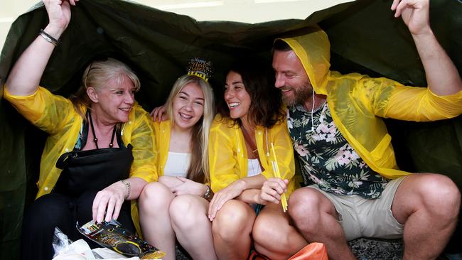 Heavy rain hasn’t dampened the spirits of New Year’s Eve revellers. Picture: Toby Zerna