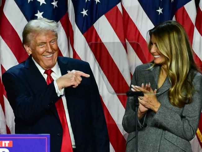 Former US President and Republican presidential candidate Donald Trump points to his wife former US First Lady Melania Trump during an election night event at the West Palm Beach Convention Center in West Palm Beach, Florida, early on November 6, 2024. (Photo by Jim WATSON / AFP)