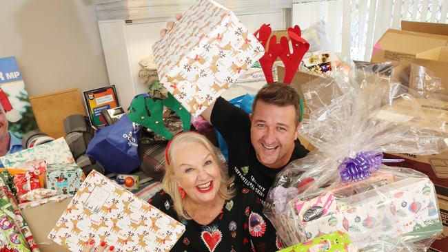 Susie Longman and Cam Christie, at Sam O'Connor's office in Labrador, sorting through donated goodies for the annual Gold Coast Community Christmas lunch. Picture Glenn Hampson