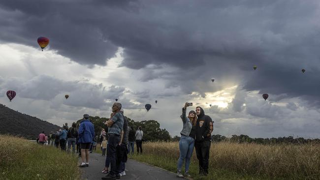 Canberra locals took selfies as Skywhale and Skywhalepapa took off on Monday. Picture: NCA NewsWire/Gary Ramage