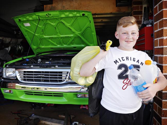 Cooper Birtles has been collecting recyclable bottles to fund the car he is restoring with dad Trent. Picture: Sam Ruttyn