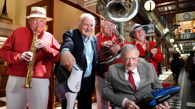 Godfreys chief executive John Hardy with 100-year old owner John Johnston and The Adelaide City Jazz Men at Godfreys’ new Adelaide Arcade store. Picture: Tricia Watkinson