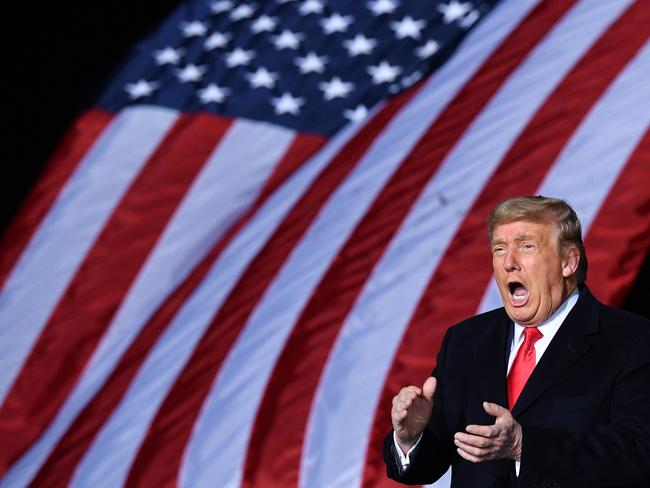 US President Donald Trump claps during a rally in support of Republican incumbent senators Kelly Loeffler and David Perdue. Picture: AFP