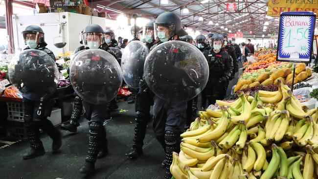 Police at Queen Victoria Market, where a tense standoff with protesters unfolded on Sunday morning. Picture: David Crosling