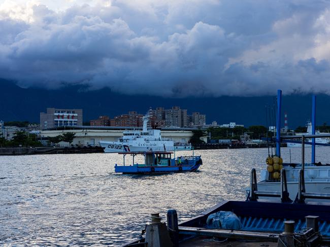 HUALIEN, TAIWAN - AUGUST 06: A marine vessel sails past a Taiwanese Coast Guard ship at Hualien Fishing Harbour on August 06, 2022 in Hualien, Taiwan. Taiwan remained tense after Speaker of the U.S. House Of Representatives Nancy Pelosi visited earlier this week, as part of a tour of Asia aimed at reassuring allies in the region. China has been conducting live-fire drills in waters close to those claimed by Taiwan in response. (Photo by Annabelle Chih/Getty Images)