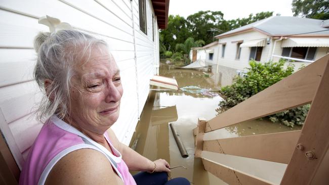 Resident Anne Smart sits on the step of her flooded house after rainwaters the day before inundated the city of Ipswich, 40 km southwest of Brisbane, Queensland on 12 January, 2011.