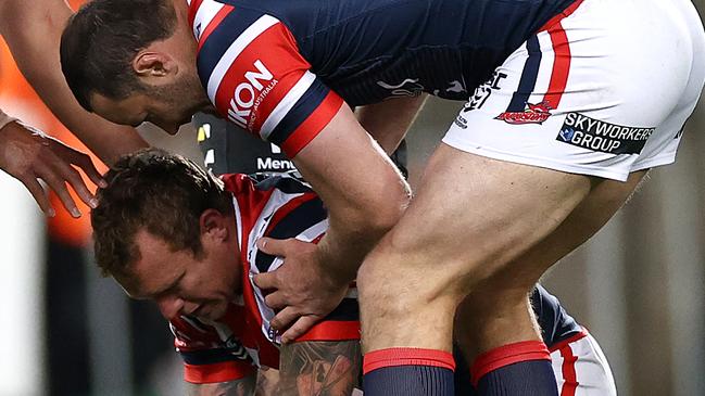 SYDNEY, AUSTRALIA - SEPTEMBER 25:  Jake Friend of the Roosters is attended to by Boyd Cordner of the Roosters after a tackle during the round 20 NRL match between the South Sydney Rabbitohs and the Sydney Roosters at ANZ Stadium on September 25, 2020 in Sydney, Australia. (Photo by Cameron Spencer/Getty Images)