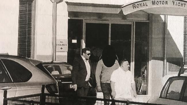 Police surveillance image alleged to be Michael Ibrahim (front in white top), Ryan Watsford (left in dark suit) and a man believed to be undercover operative MW1 leave Point Piper's Royal Motor Yacht Club on May 5 after a meeting in which Watsford claimed to be starring in a drug bust movie.