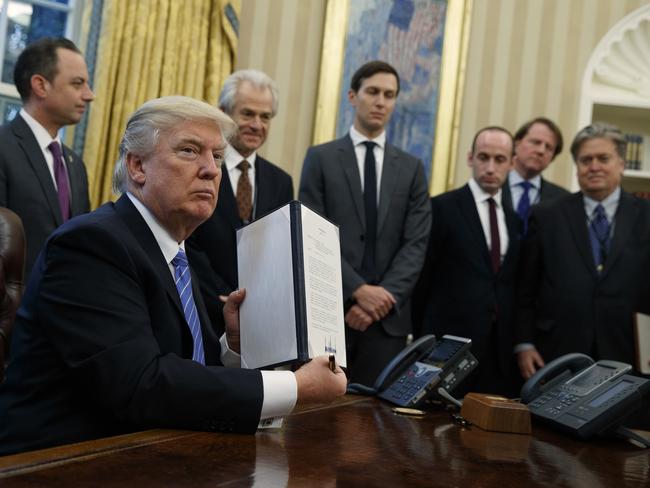 President Donald Trump shows off a signed executive order to reinstitute a policy barring any recipient of US assistance from performing or promoting abortions abroad. Picture: Evan Vucci/AP Photo