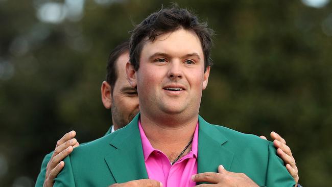 Patrick Reed of the United States is presented with the green jacket.