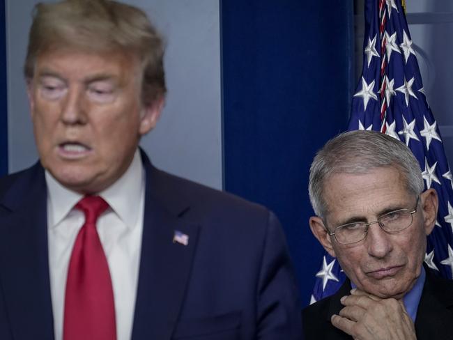 Dr. Anthony Fauci, with Donald Trump, has questioned whether the UK was too quick to approve a coronavirus vaccine. Picture: Getty Images