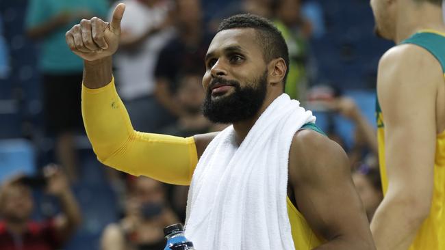 Australia's Patty Mills waves to fans.