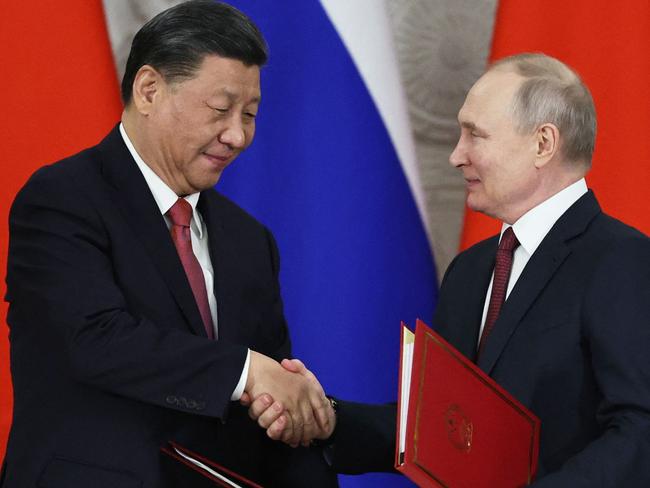 Russian President Vladimir Putin and China's President Xi Jinping shake hands during a signing ceremony following their talks at the Kremlin in Moscow on March 21, 2023. (Photo by Mikhail TERESHCHENKO / SPUTNIK / AFP)