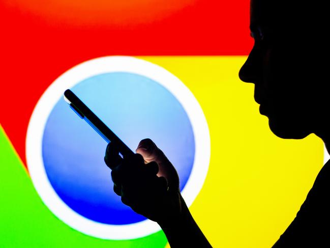 BRAZIL - 2022/04/27: In this photo illustration, the Google Chrome logo is seen in the background of a silhouetted woman holding a mobile phone. (Photo Illustration by Rafael Henrique/SOPA Images/LightRocket via Getty Images)