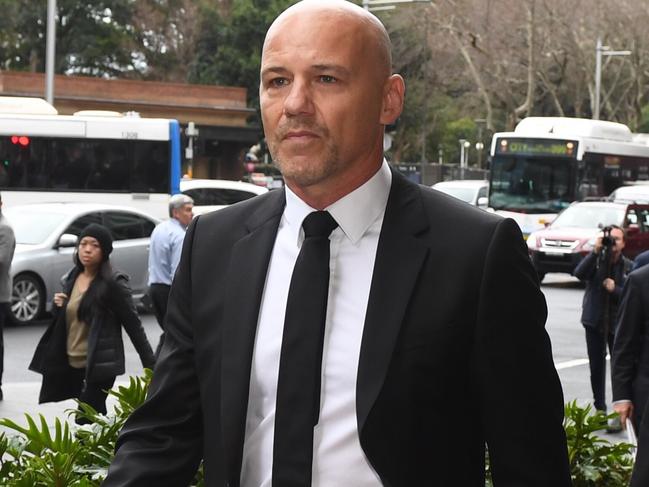 Former NSW Detective Gary Jubelin (left) arrives with his lawyer Margaret Cunneen at Down Centre Courts in Sydney Tuesday, July, 30, 2019. NSW detective Gary Jubelin, who led the fresh search for three-year-old William Tyrell, is due to face a Sydney court on surveillance charges. (AAP Image/Dean Lewins) NO ARCHIVING