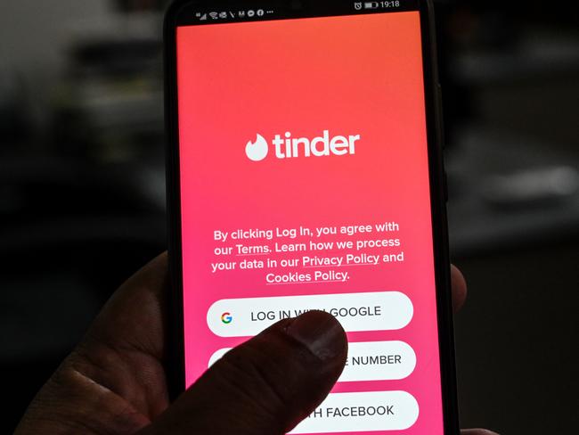 In this picture taken on October 6, 2020, a user checks the dating app Tinder on a mobile phone in Islamabad. - Unlike in many countries where meeting online is routine, Pakistanis who use dating apps regularly face harassment and judgmental relatives -- and now also have to contend with a government clampdown. (Photo by Aamir QURESHI / AFP) / To go with 'PAKISTAN-MARRIAGE-DATING', FOCUS by David Stout and Kaneez Fatima in Lahore