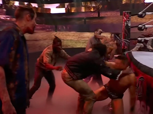 A group of zombies attack The Miz and Damien Priest.