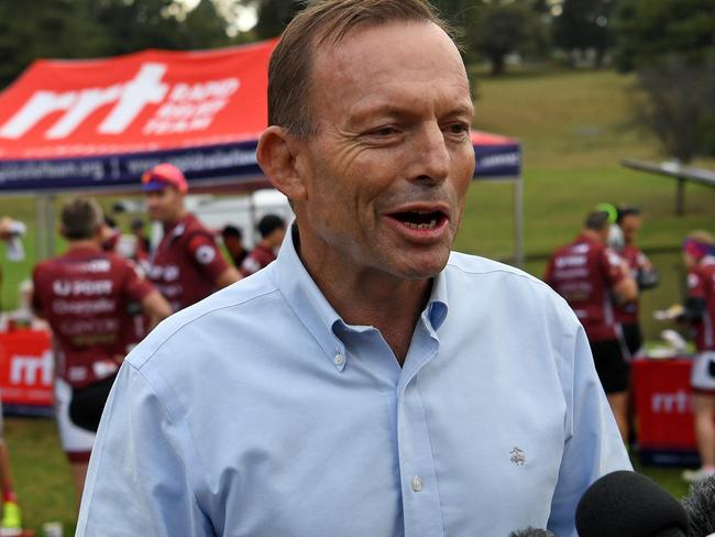 Former prime minister Tony Abbott speaks to the media at Warragul before taking part in the Pollie Pedal Bike Ride through Gippsland, Victoria, Monday, April 9, 2018. Tony Abbott is sharing his words of wisdom as his coalition successor racks up the 30th Newspoll loss for the federal government. As Malcolm Turnbull matched the test he set when he deposed Mr Abbott, the former prime minister again urged the government to champion low power prices, by keeping coal, and higher wages, by cutting immigration. (AAP Image/Joe Castro) NO ARCHIVING