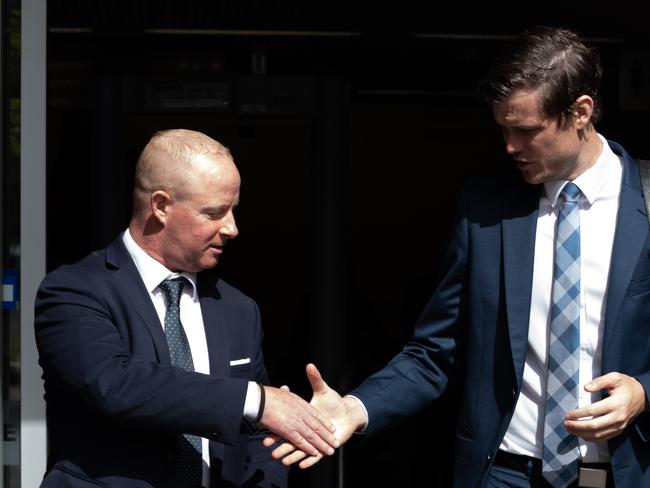 John Paul Ryan (left) shakes hands with his lawyer upon leaving Waverley court. Picture / Monique Harmer