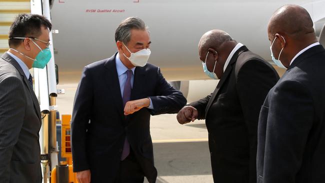 Papua New Guinea officials receive Chinese Foreign Minister Wang Yi (C) as he arrives as part of his Pacific tour. Picture: AFP.