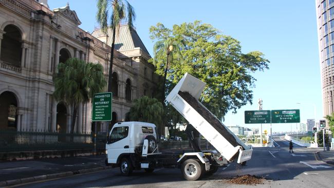 A pile of manure is dropped outside Parliament House by Extinction Rebellion activists. Picture: Nathan Edwards