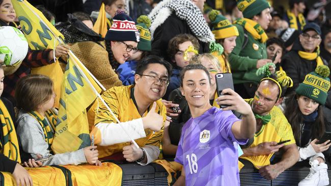 Matildas goalkeeper Mackenzie Arnold signs autographs after the friendly between Australia and France. Picture: Reuters