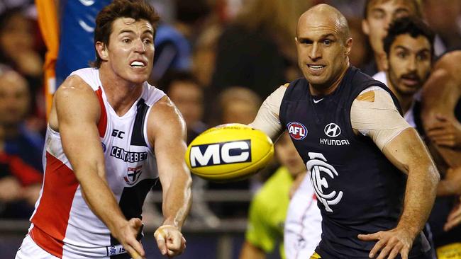 Lenny Hayes and Chris Judd go head to head. Picture: Michael Klein